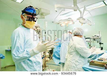 surgeons in uniform during heart transplantation operation on a patient at cardiac surgery clinic
