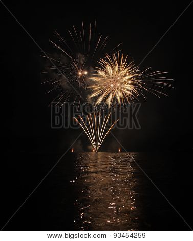 Colorful Fireworks With Reflection On Lake.