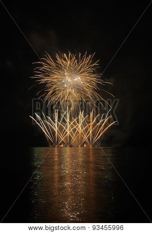 Colorful Fireworks With Reflection On Lake.