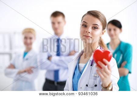 Female doctor with stethoscope holding heart .