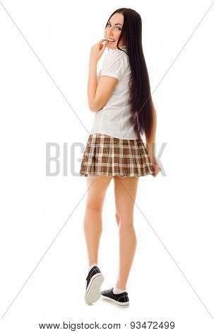 Young modest girl in plaid skirt isolated