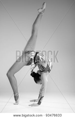 Beautiful young woman limber exerciser in the studio