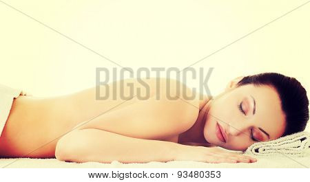 Woman lying on a towel ready to massage.