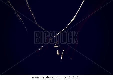 Woman's and man's hands together.