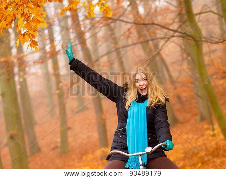 Girl Relaxing In Autumnal Park With Bicycle