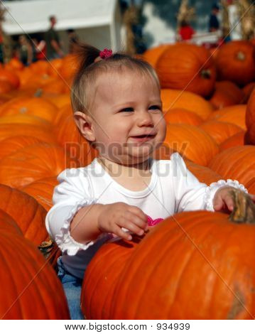 Smiling Baby With Pumpkins