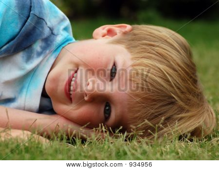 Cute Boy In Grass