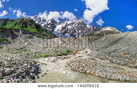 Summer landscape with river and mountain snow. Peak Shkhara Zemo Svaneti, Georgia. The main Caucasian ridge