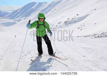 Murmansk regionRussia - April 11 2013: a young woman rises in the snowy slopes on skis in Hibiny mountains.