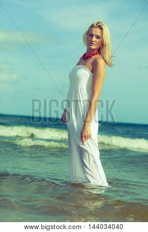 Attractive Blonde Woman On The Beach.