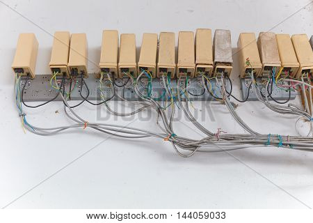 Old cluster of telephone connection boxes on wall