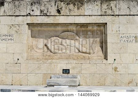 Athens, Greece. Tomb of The Unknown Soldier outside Greek Parliament. It depicts a dead soldier lying, with his shield on his left hand.