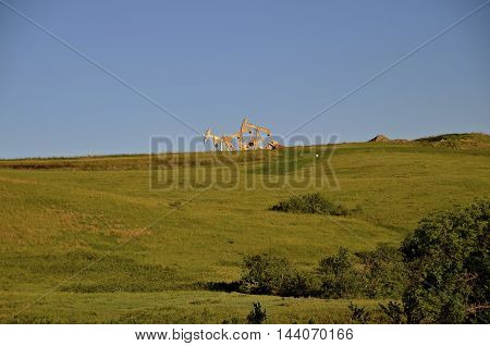 The tops of oil pumps in the western North Dakota oil fields can be seen in the skyline