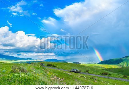 The rain in highland with the bright rainbow among the clouds Syunik Province Armenia.