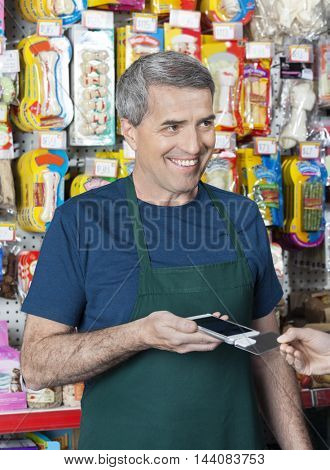 Salesman Accepting Credit Card Payment From Customer