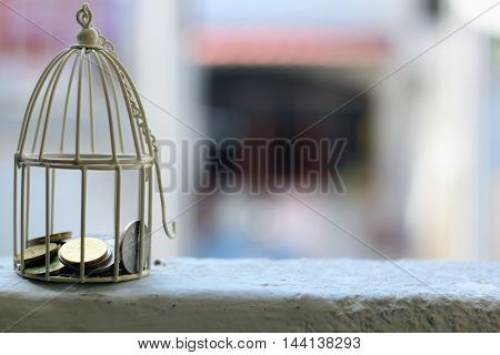 White cage with Malaysia Coin money inside with selective focus and blur background