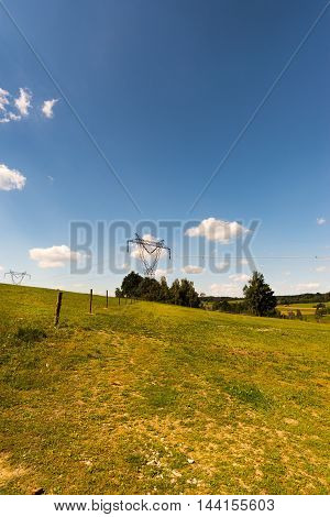 Big Steel Electric Pillar On The Grassland