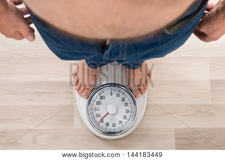 Low Section Of A Person Standing On Weighing Scale
