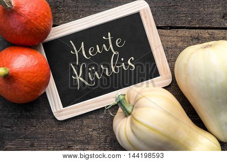 Hokkaido Pumpkins And Butternut Squash On Wooden Table, Slate With Text