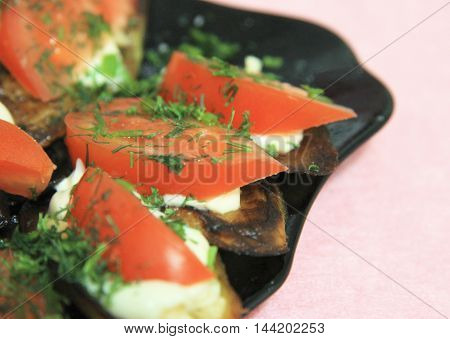 Fried eggplants and fresh tomato with souce and herbs