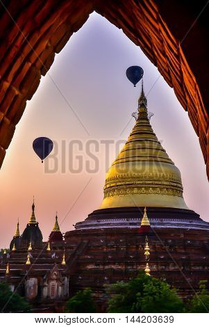 Dhammayazika pagoda in misty morning light in Bagan. This Dhammayazika  pagoda gilded with Bagan gold leaves is ancient and most visited in Bagan. It is located east of Bagan, Myanmar.