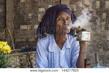 Bagan, Myanmar, September 2014: Old woman smoking a cigar