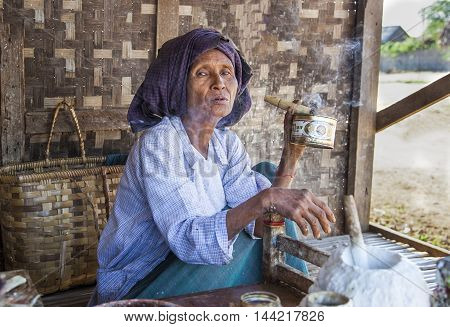 Bagan, Myanmar, September 2014: Old woman smoking a cigar