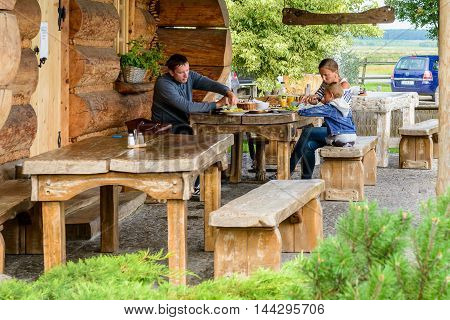 HORBOW, POLAND - AUGUST 17, 2014: Unidentified people eat at the Pajero Hotel in Horbow, Poland. Pajero hotel is located on the International road E-30, 20 km from the Belorussian Frontier