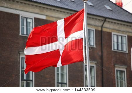 Waving Danish flag on the mast in Copenhagen Denmark