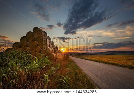 Sunset and the pyramid of straw bales. Moravian landscape Boskovice.