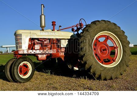 MADISON, SOUTH DAKOTA, August 20, 2016: A restored and freshly painted Farmall C tractor is a brand manufactured  by the American company International Harvester. Co. IH