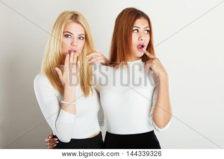 Friends goals concept. Two ladies in awkward moment. Blonde girl together with  lady Standing next to each other. Attractive girls has nice outfit.