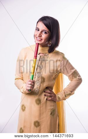Indian beautiful young girl with garba sticks on Indian Festival Navratri, isolated on white background