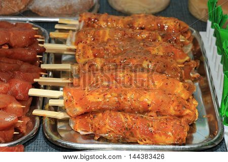 Fresh poultry products for barbecue on display at a poulterer store