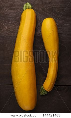 Harvested big and medium zucchini. Fat and thin.Close up background.Vertical shot.Rustic bakground