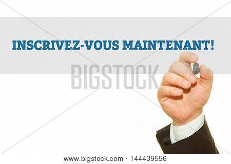 Hand writing French Slogan INSCRIVEZ-VOUS MAINTENANT! (Register NOW!) on a transparent wipe board.
