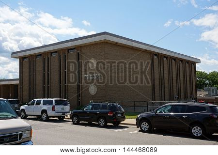 PETOSKEY, MICHIGAN / UNITED STATES - AUGUST 5, 2016: The Emmet County Building houses the Emmet County Courthouse and various government offices on Division Street in downtown Petoskey.