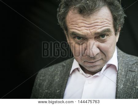 Portrait of artful men, look askance.