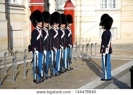 COPENHAGEN DENMARK - AUGUST 15 2016: Danish Royal Life Guards on the central plaza of Amalienborg palace home of the Danish Royal family in Copenhagen Denmark on August 15 2016.