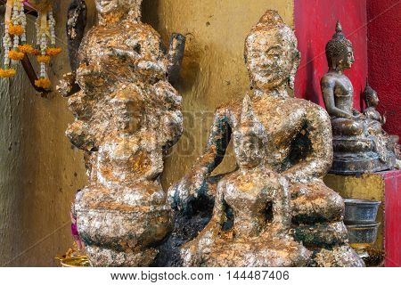 Old golden Buddha Statue (Bayon Style) with gold leaf.