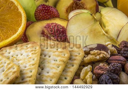 Snacks background, fruits, nuts, crackers  - Background image with snacks healthy fruits and nutritious nuts and crackers.