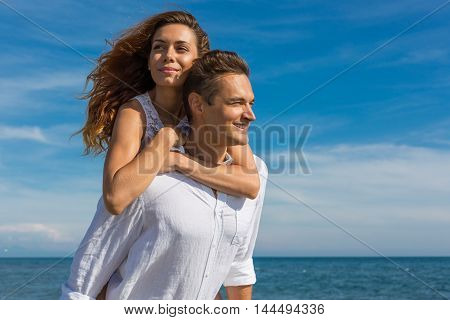 happy couple in love walking on the beach in summer white dress