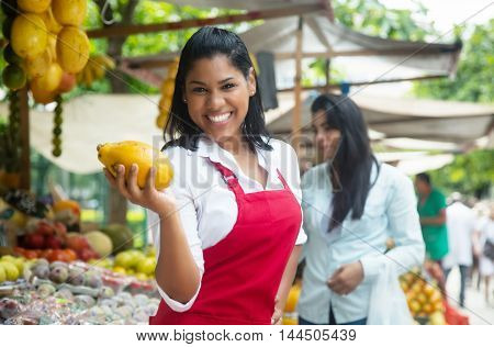 Mexican saleswoman on a farmers market selling fresh fruits
