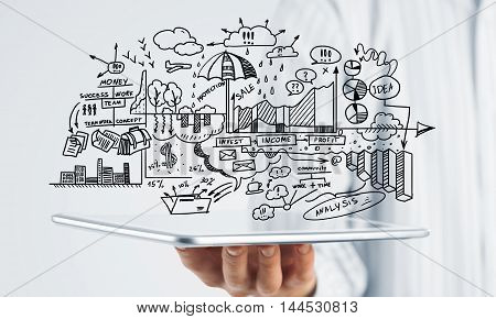 Businessman hand demostrating business strategy plan on tablet screen