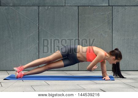 Fit Young Woman Doing Planks