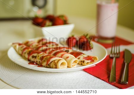 breakfast pancakes with strawberry jam and jogurt