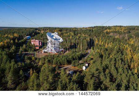 Aerial view radio telescope in forest at countryside in saint-Petersburg Russia