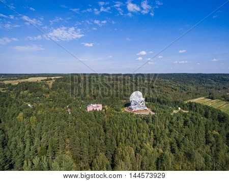 Aerial view radio telescope in forest at countryside in saint-Petersburg Russia