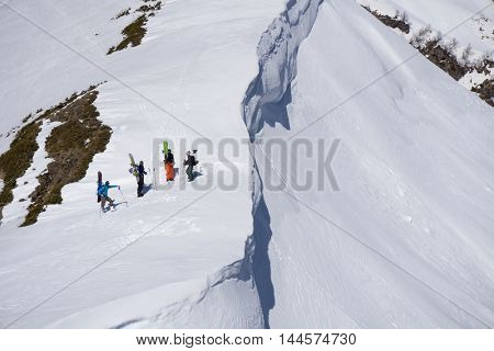 Snowboarders walking uphill for freeride, extreme sport