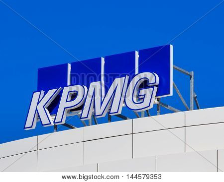 Basel, Switzerland - 27 August, 2016: KPMG sign on the top of an office building. KPMG is a professional service company headquartered in Amsterdam, it is one of the largest auditors worldwide.
